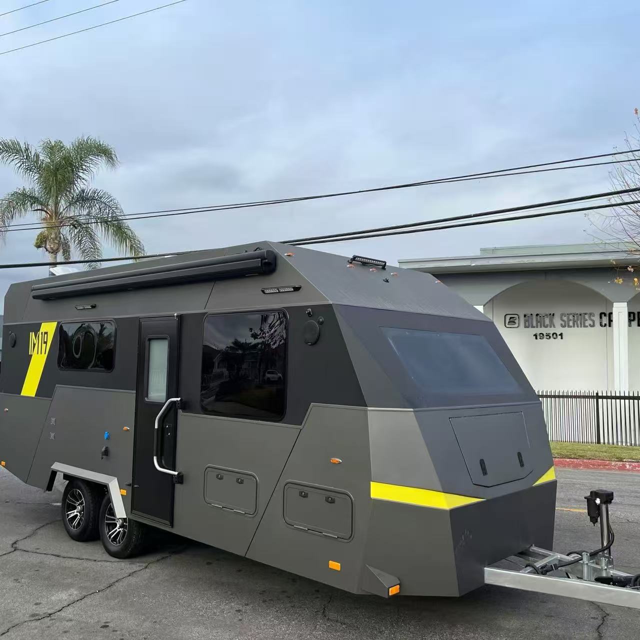 VOLREK IM19 gray hardtop travel trailer with bright yellow accents